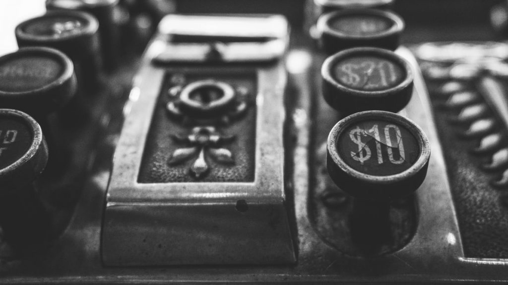 An illustrative image to the article on alternatives to GDP. A A black-and-white photo of an old cashier's machine.